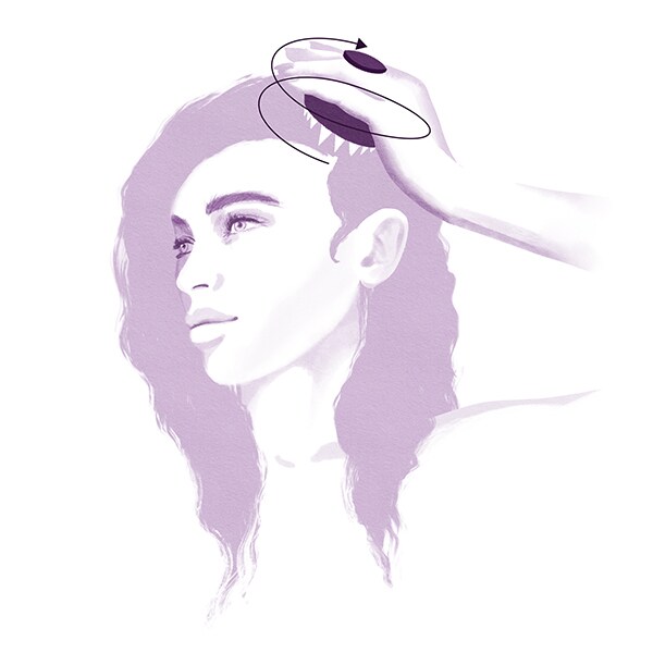 Step 2: Using the invati advanced scalp massager, work in circular motions from the hair line to the crown of the head.