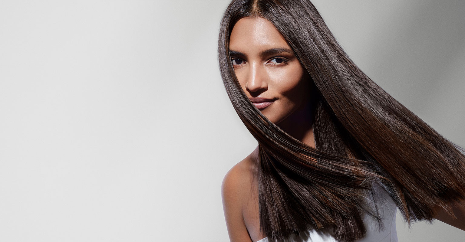 brunette woman holder hair hair with her right hand