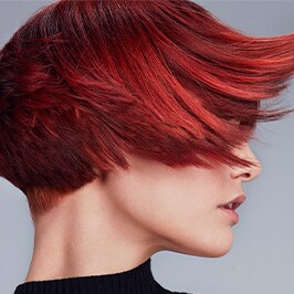 woman with short red hair in black turtle neck