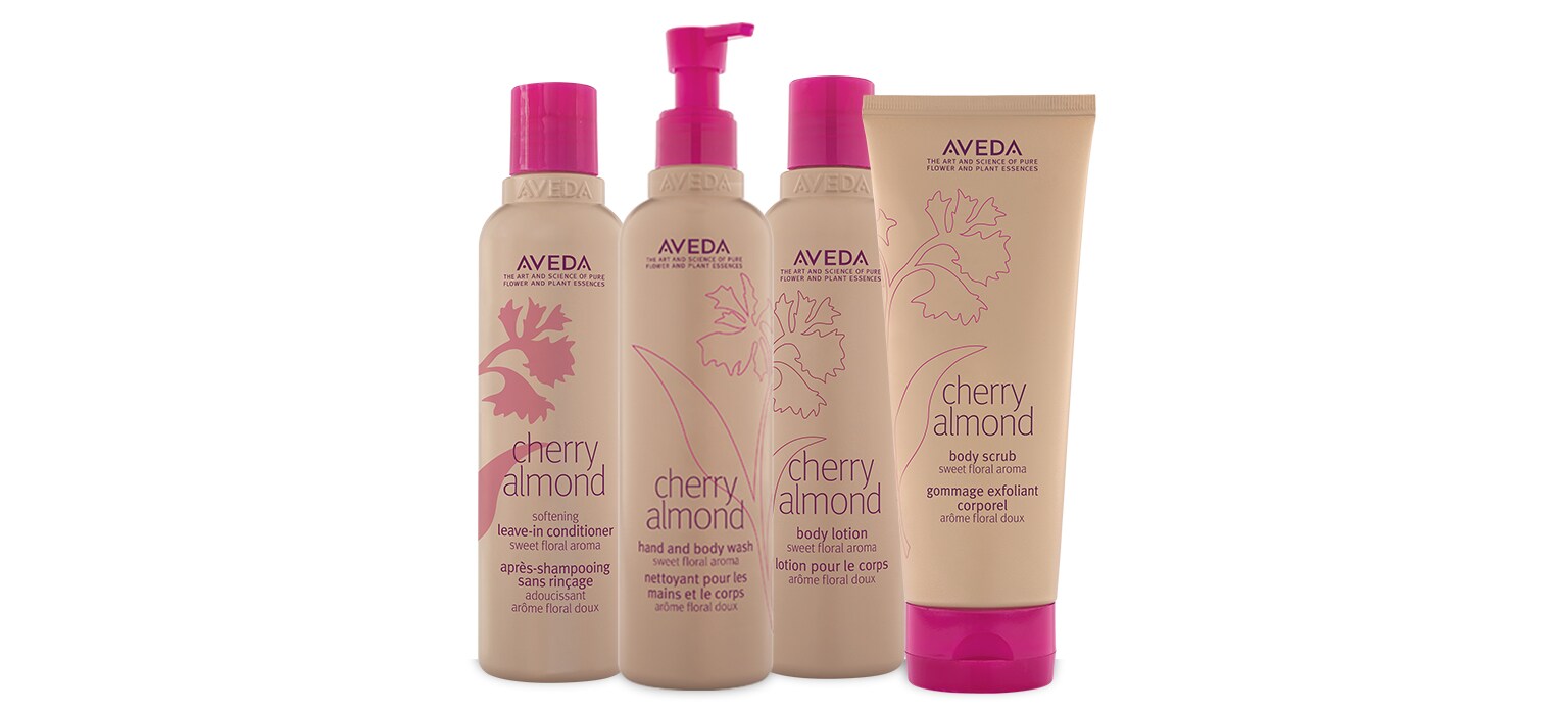 free full size cherry almond body scrub, body lotion, hand and body wash, and leave-in conditioner on white background