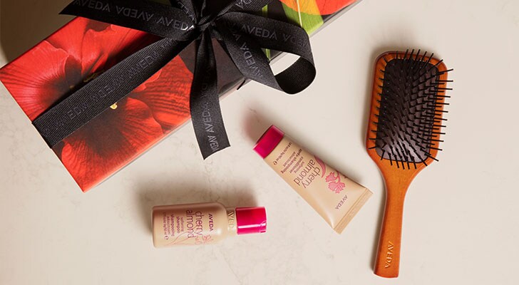 online exclusive set including travel size cherry almond shampoo and conditioner and a mini paddle brush